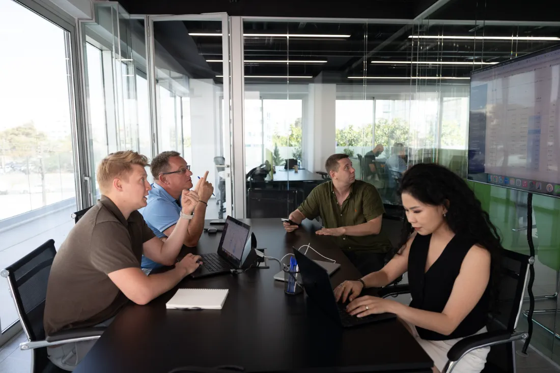 The team in a planning session by the windows